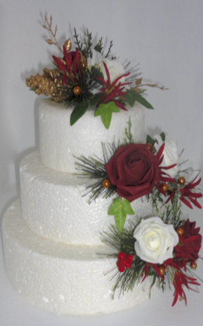 red & ivory roses with gold pine cones, red berries tweedia, pine foliage & gold pearls and leaf sprays